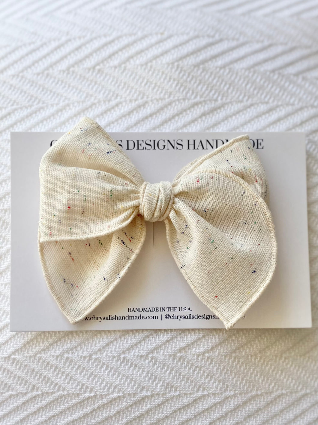 Cream linen with multi-color spots fable bow